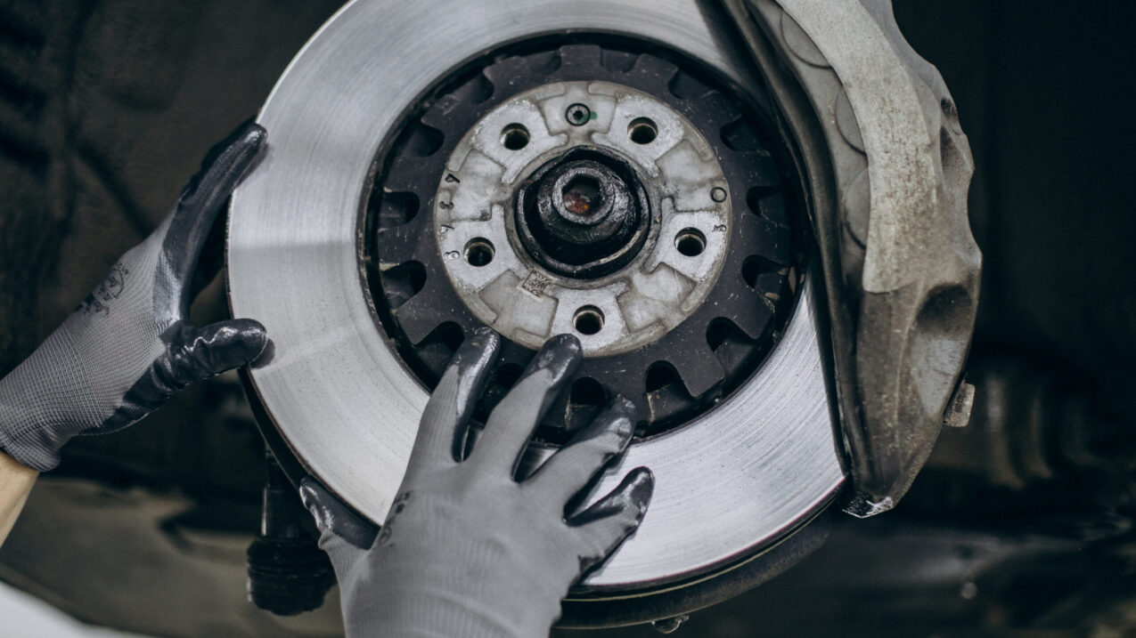 Mechanic changing brake discs in car service