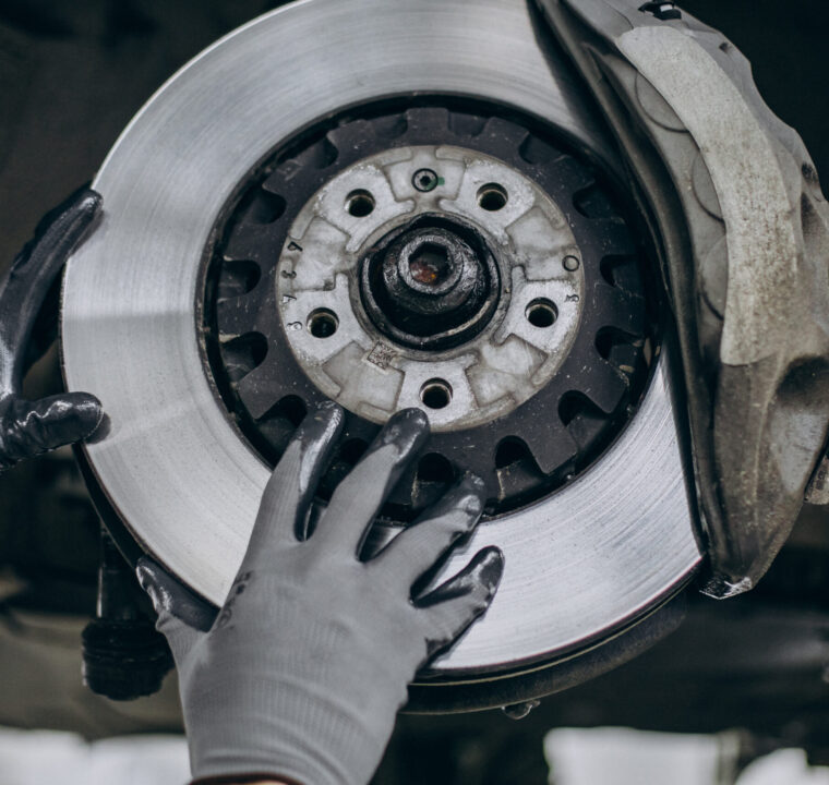 Mechanic changing brake discs in car service